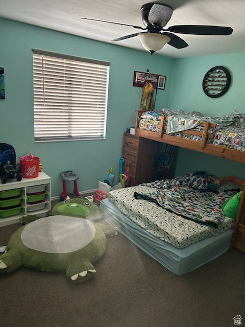 Carpeted bedroom with ceiling fan