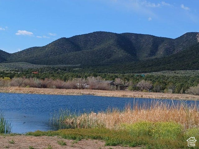 Property view of mountains featuring a water view