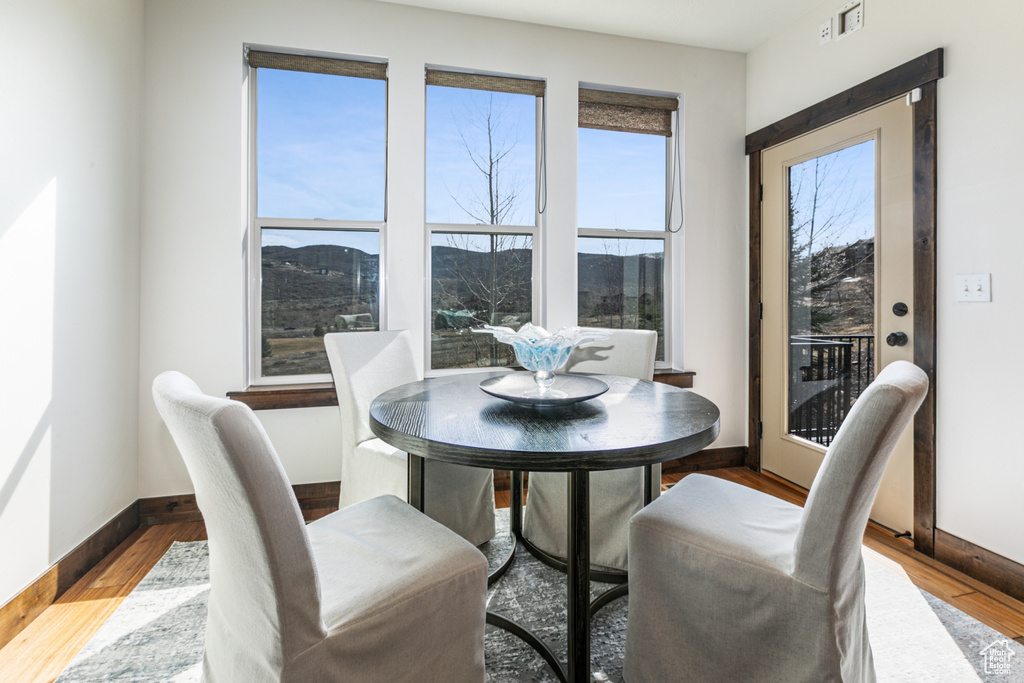 Dining area featuring a mountain view and hardwood / wood-style flooring