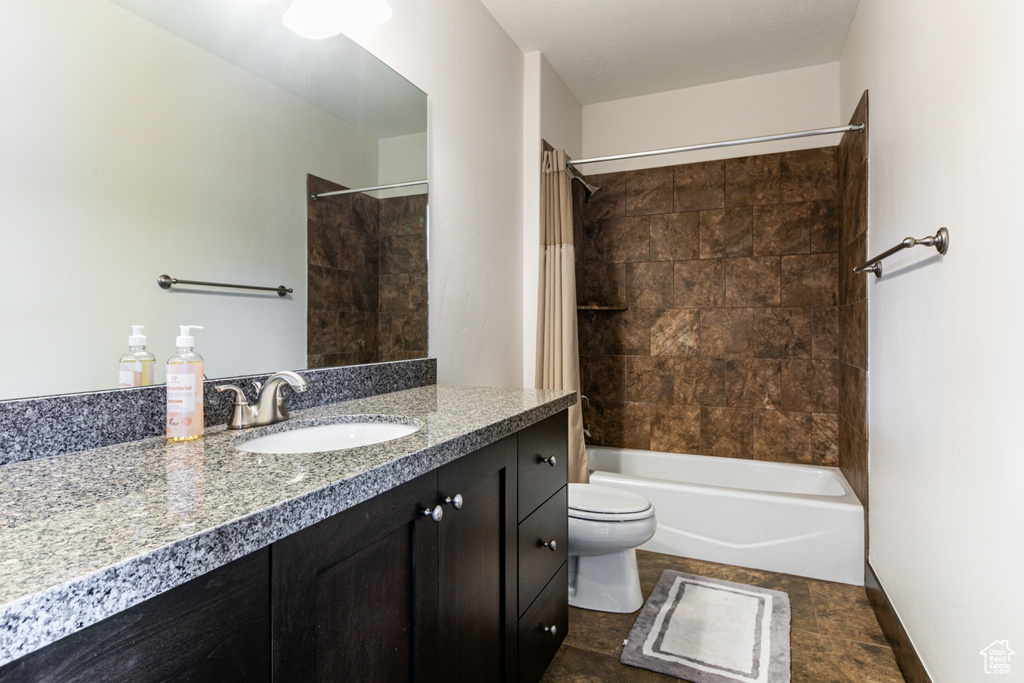 Full bathroom with vanity, toilet, and shower / bath combo