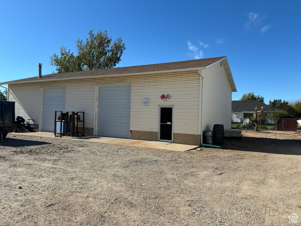 View of outbuilding with a garage