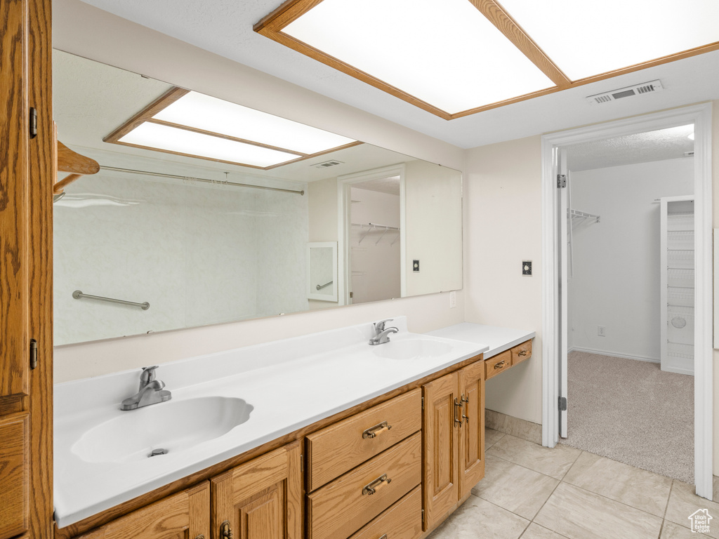 Bathroom featuring vanity and tile patterned floors