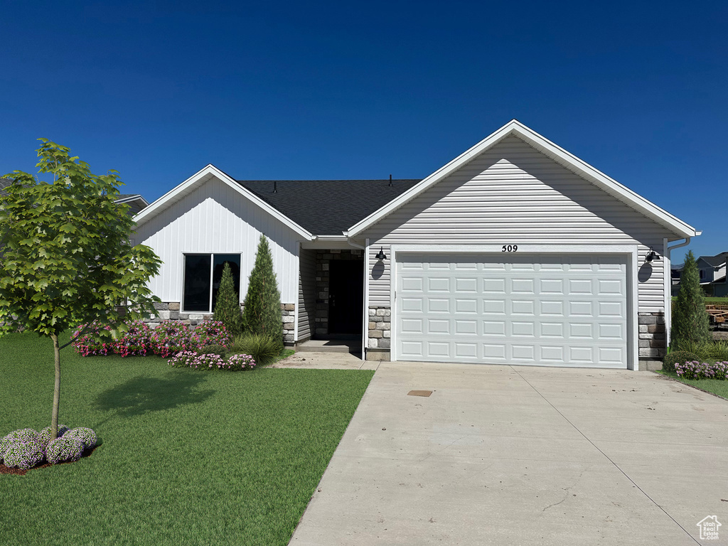 Single story home with a front lawn and a garage