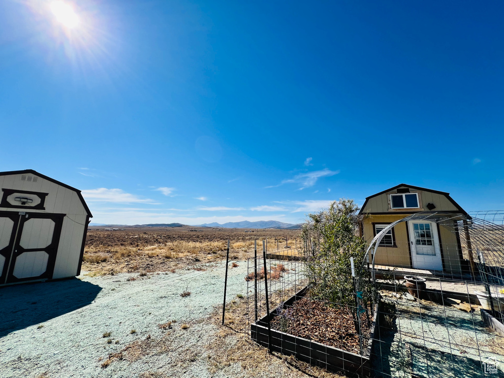 View of yard featuring a storage shed and a mountain view