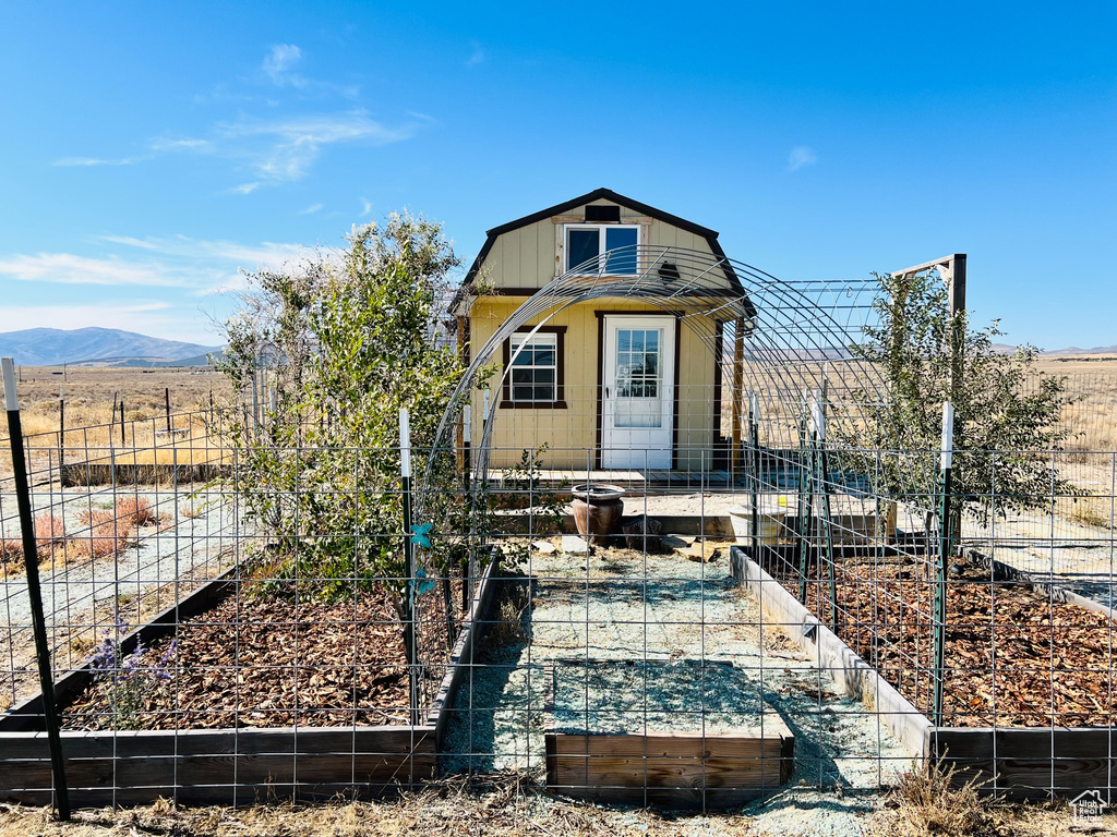 Rear view of house featuring a mountain view