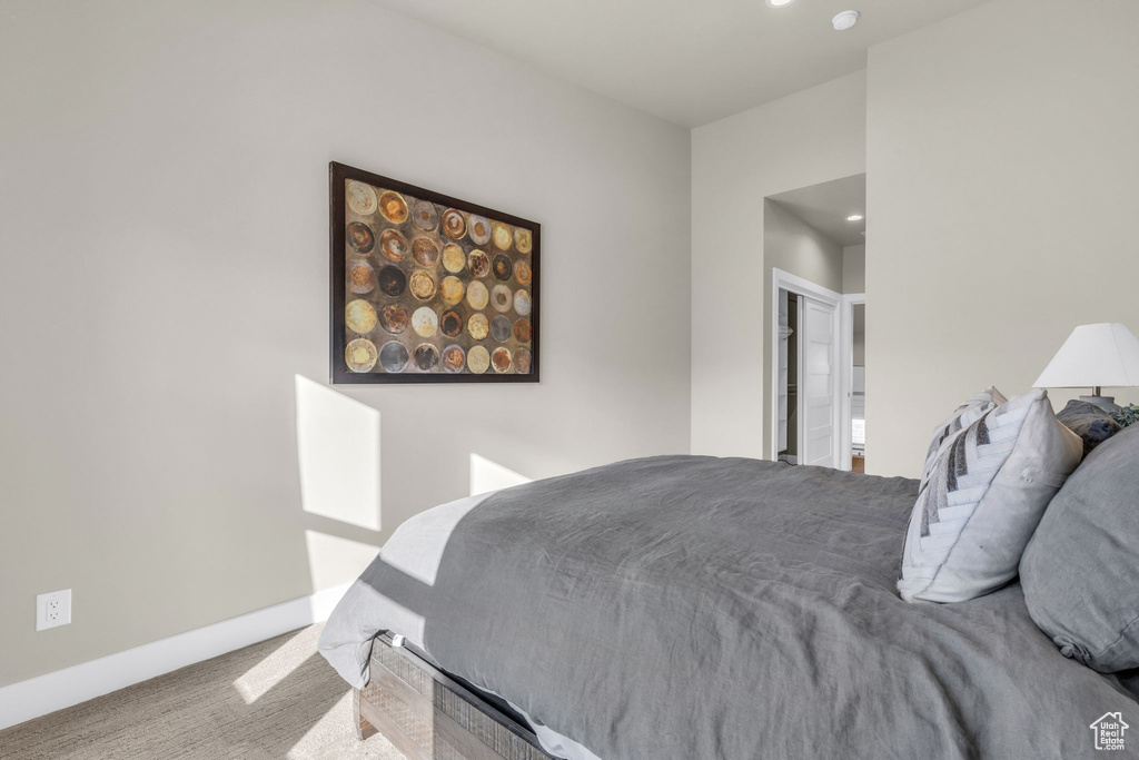 Carpeted bedroom with a closet and ensuite bath