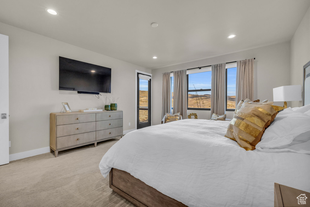 Bedroom featuring light colored carpet