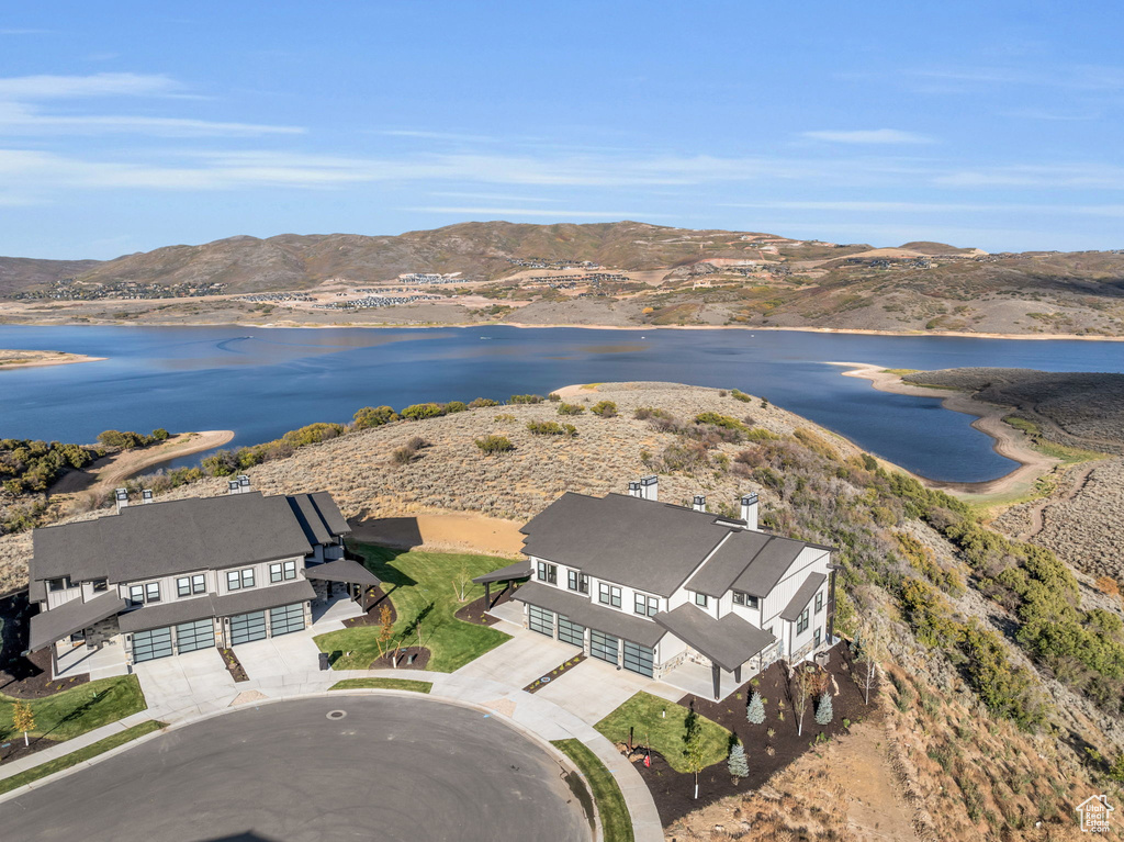 Birds eye view of property featuring a water and mountain view