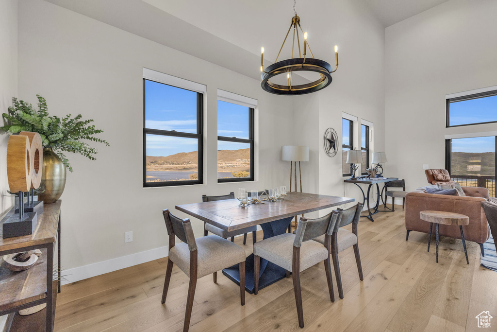 Dining room featuring light hardwood / wood-style floors, a mountain view, and an inviting chandelier