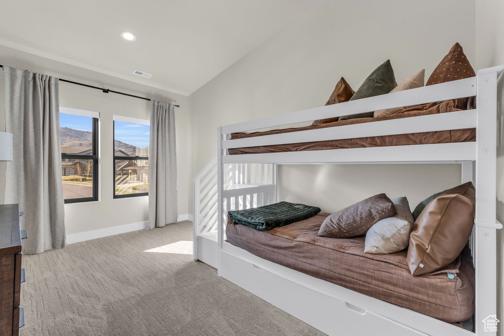 Carpeted bedroom with vaulted ceiling