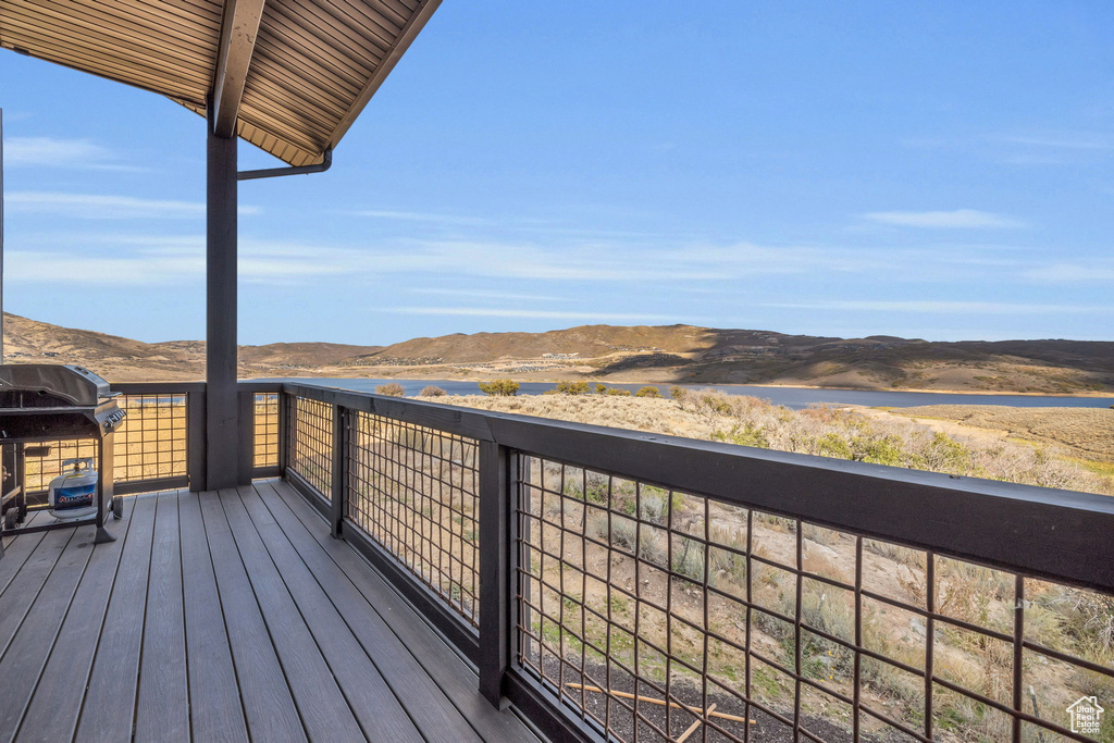 Wooden terrace featuring area for grilling and a mountain view