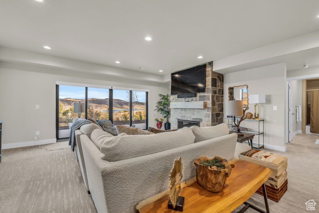 Living room with a fireplace and light colored carpet