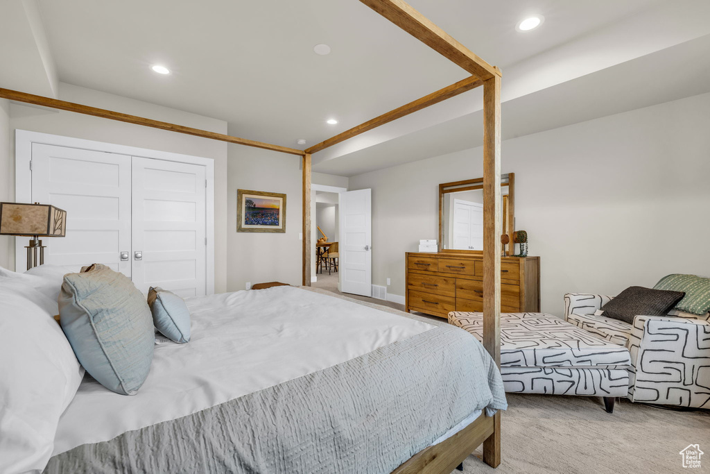 Carpeted bedroom featuring a closet