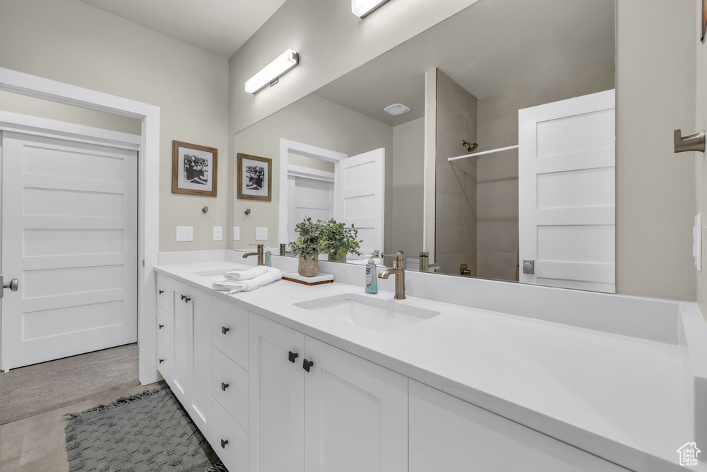 Bathroom with vanity, walk in shower, and tile patterned floors