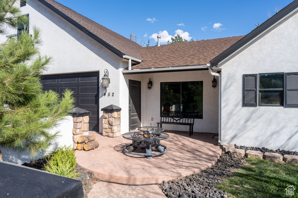 View of patio with a garage