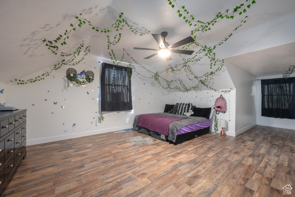 Bedroom featuring dark wood-type flooring and ceiling fan