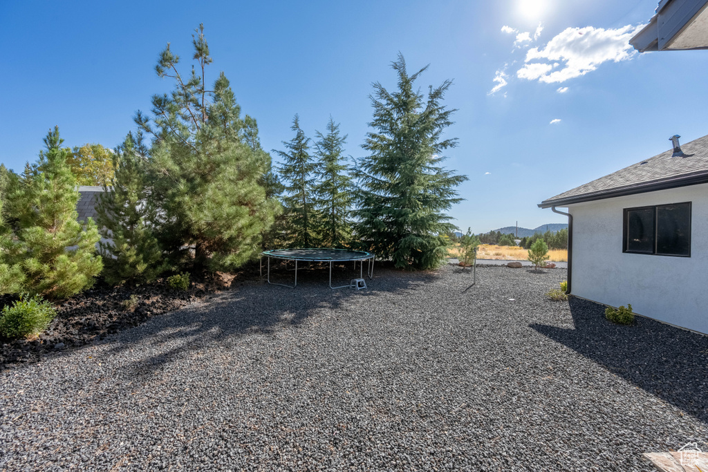 View of yard featuring a mountain view and a trampoline