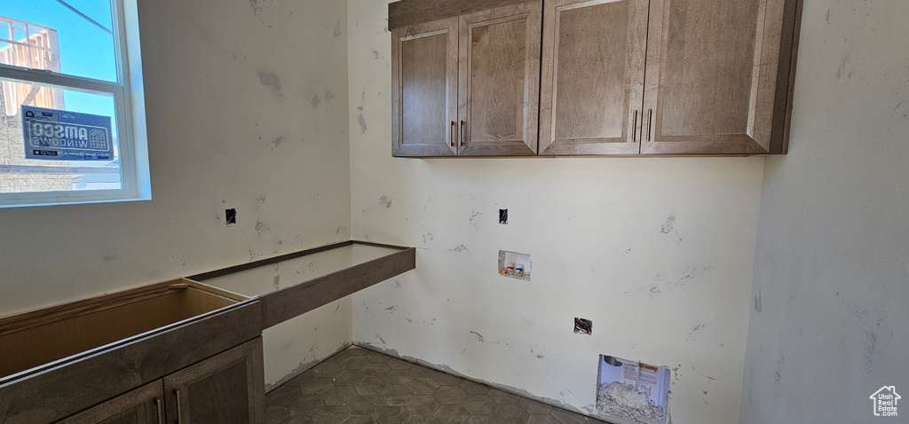 Clothes washing area featuring cabinets and washer hookup