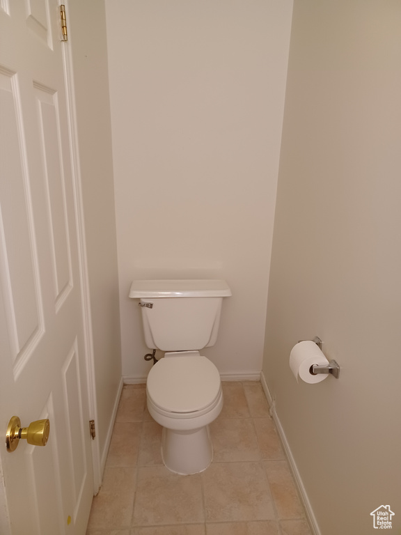 Bathroom featuring toilet and tile patterned flooring