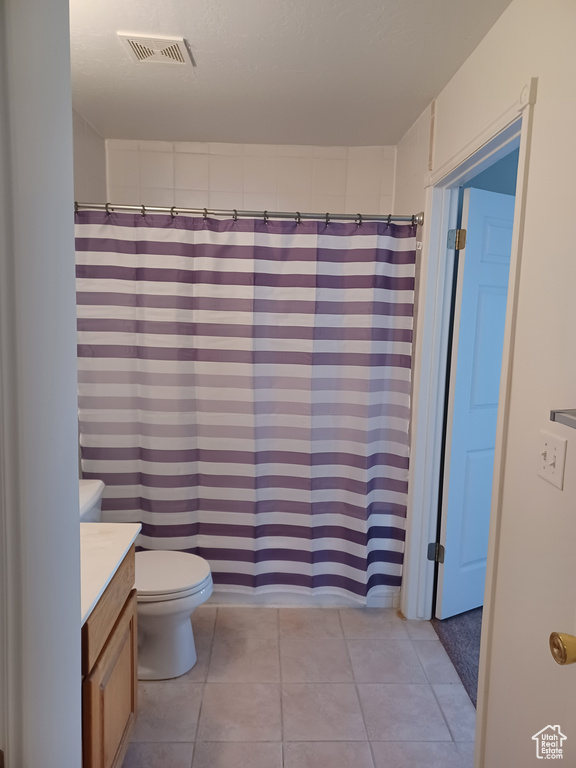 Bathroom featuring vanity, a shower with curtain, and toilet