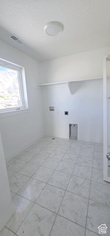 Clothes washing area featuring hookup for a washing machine and electric dryer hookup