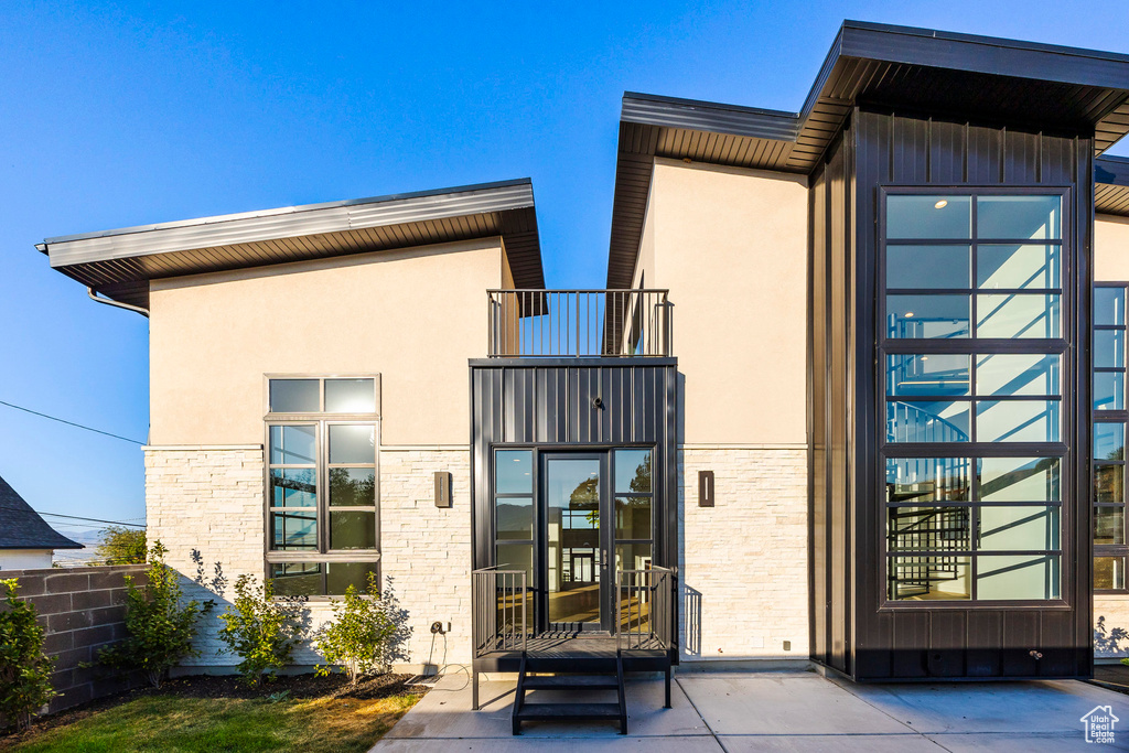 Rear view of property with a balcony