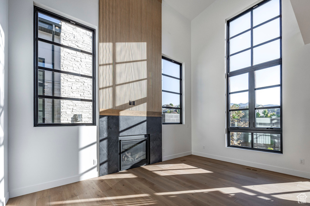 Interior space featuring wood-type flooring and a high ceiling