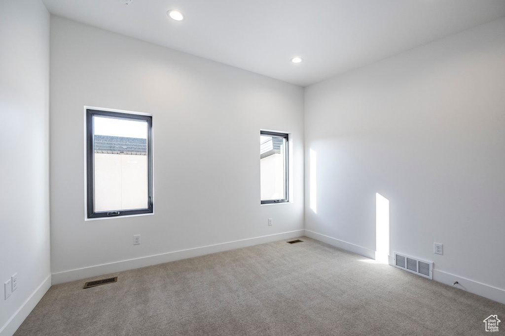 Carpeted empty room with a healthy amount of sunlight