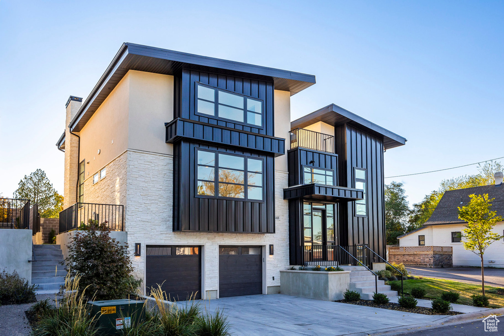 Modern home featuring a balcony and a garage