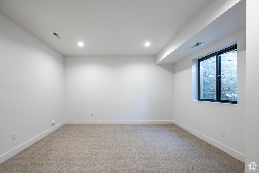 Unfurnished room with light colored carpet