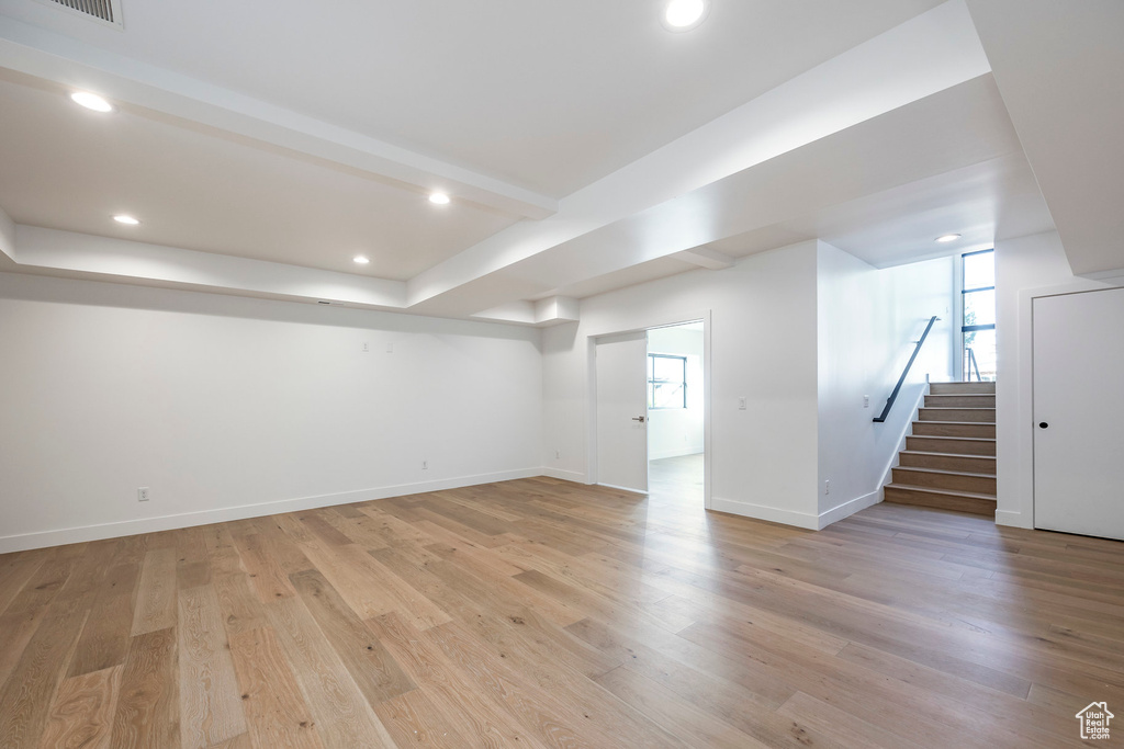 Basement with light wood-type flooring