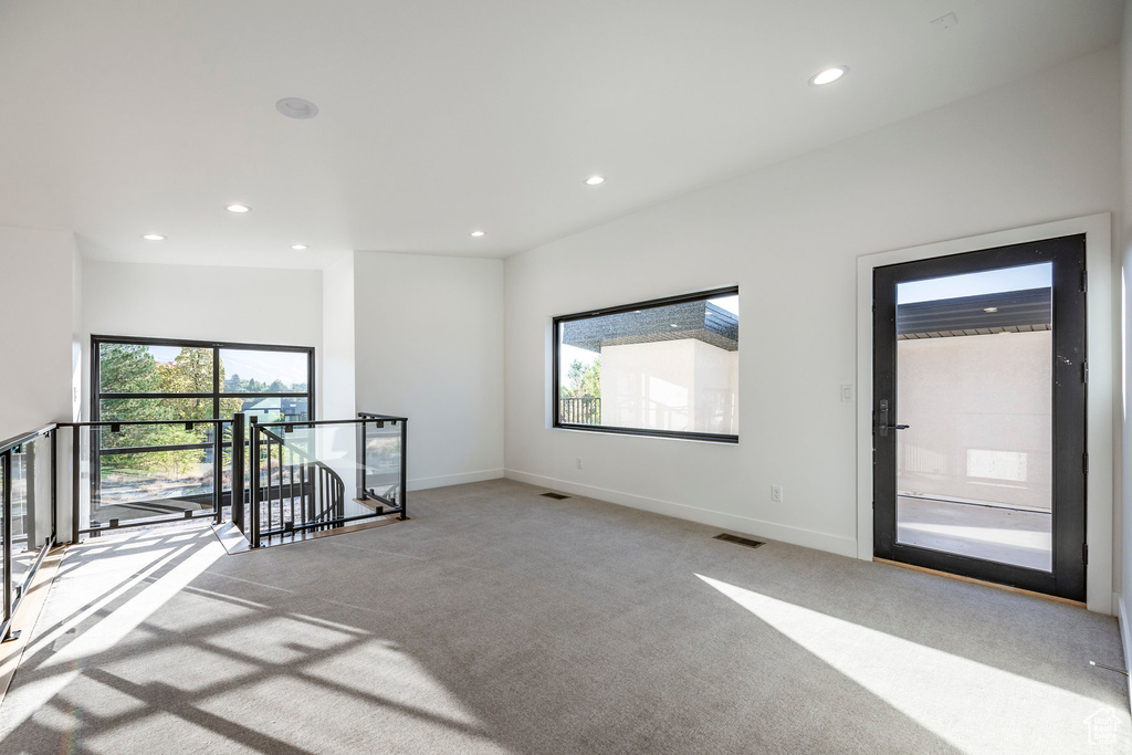 Empty room featuring light carpet