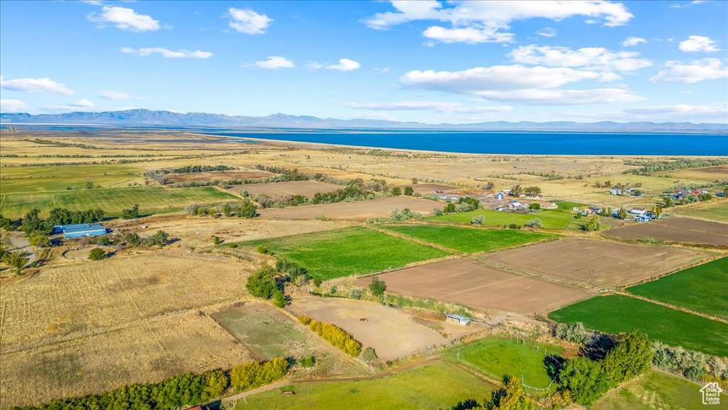 Drone / aerial view featuring a water and mountain view and a rural view