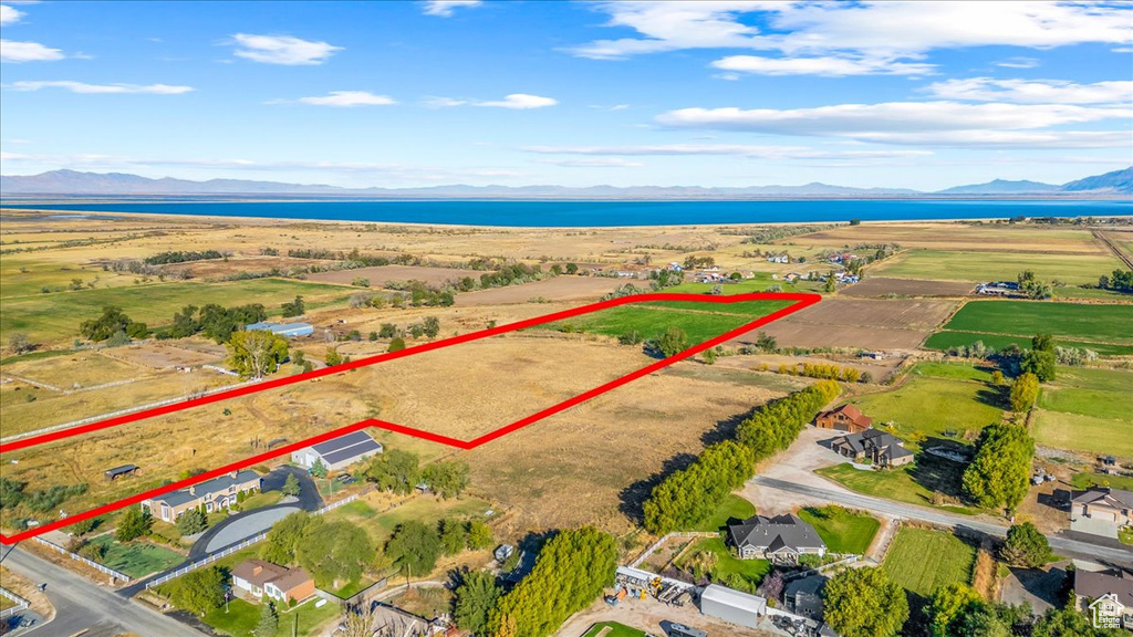 Birds eye view of property featuring a water and mountain view