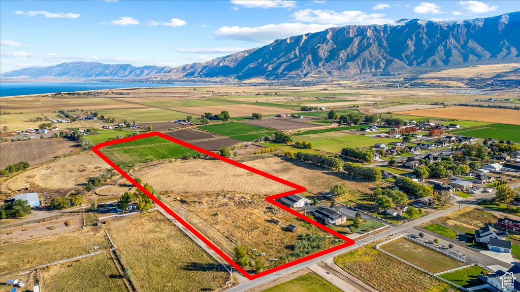 Birds eye view of property featuring a water and mountain view