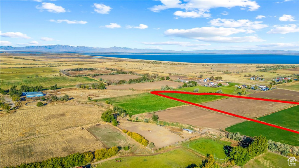 Birds eye view of property with a water and mountain view