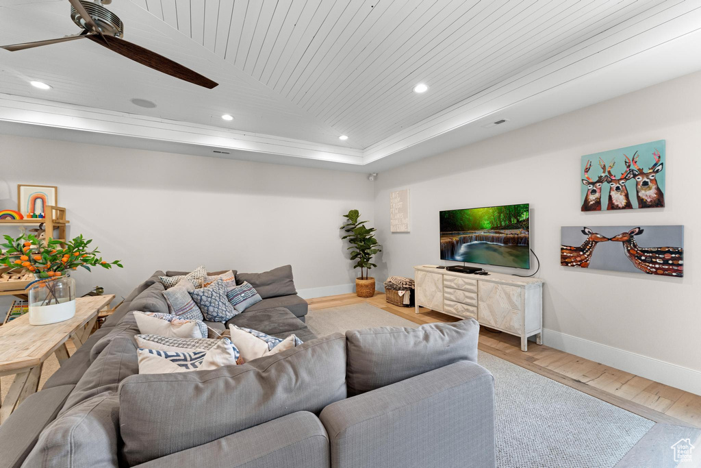 Living room featuring hardwood / wood-style floors, a tray ceiling, wooden ceiling, and ceiling fan