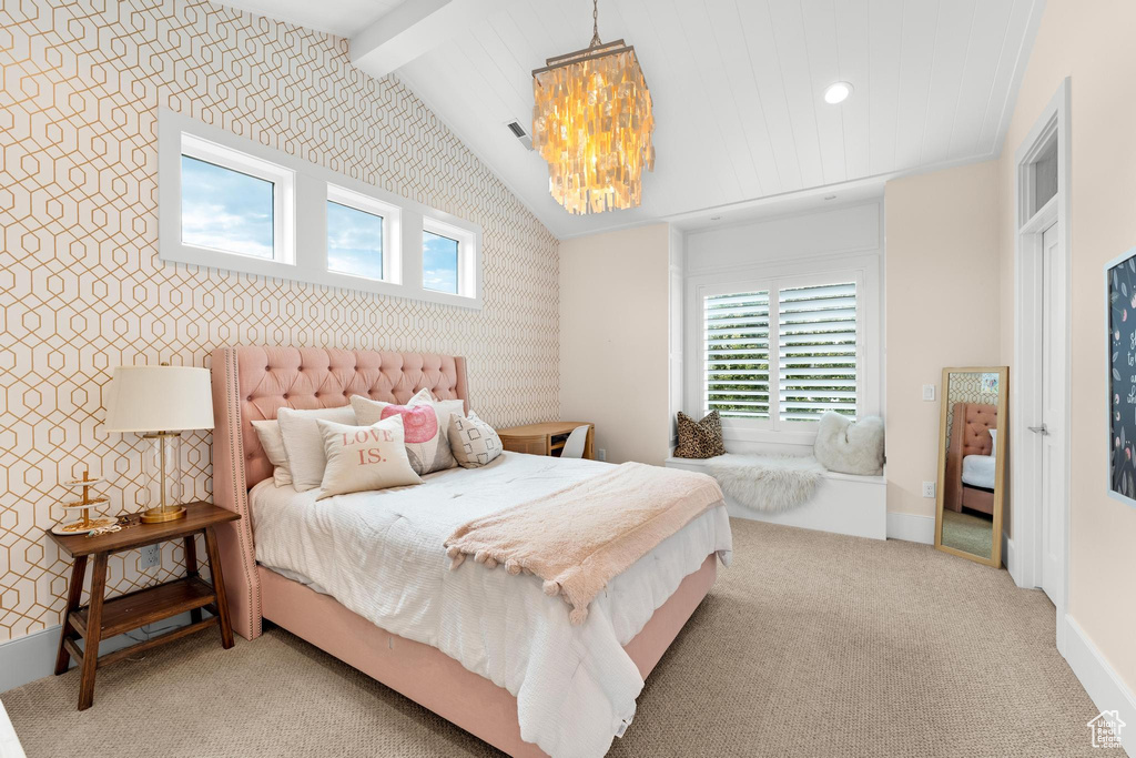 Carpeted bedroom with vaulted ceiling with beams, multiple windows, and a chandelier