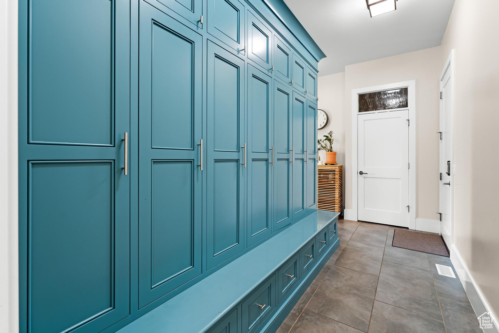 Mudroom with dark tile patterned floors