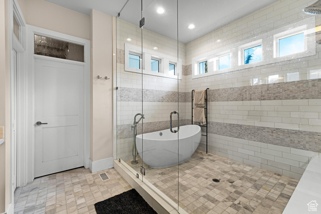 Bathroom featuring separate shower and tub