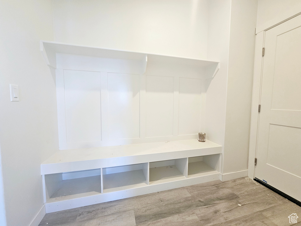 Mudroom with light hardwood / wood-style floors