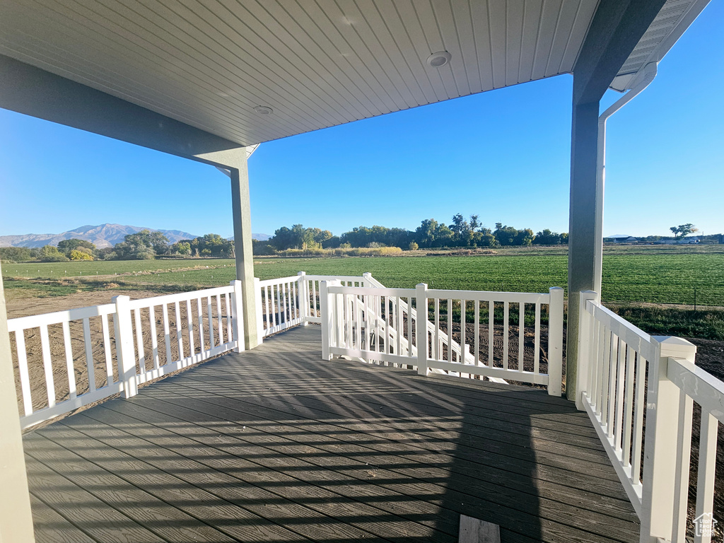 Wooden terrace featuring a mountain view and a rural view