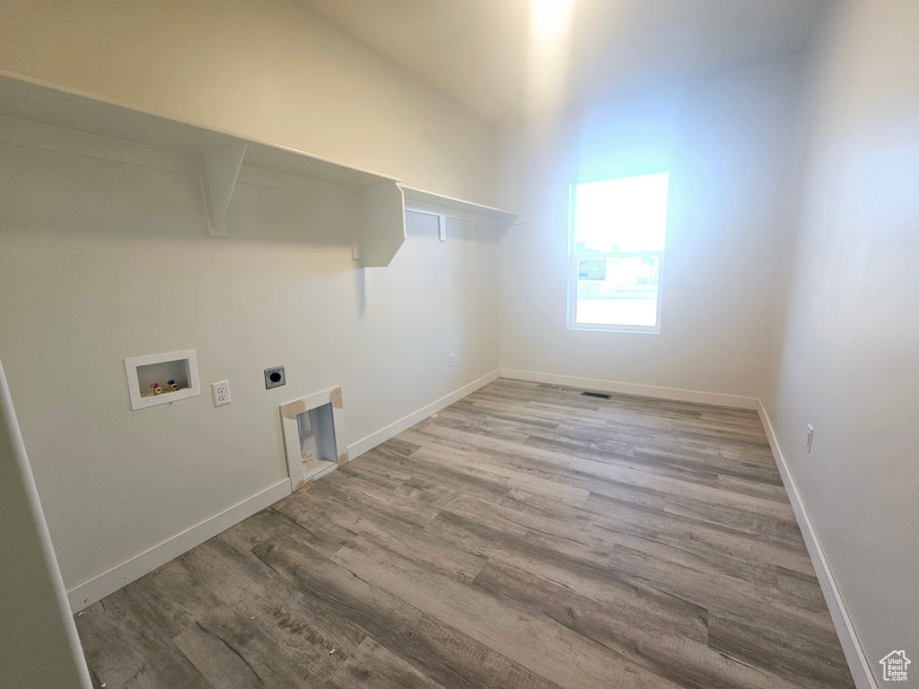 Washroom featuring electric dryer hookup, washer hookup, and light hardwood / wood-style floors