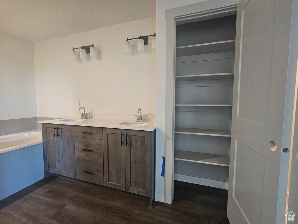 Bathroom featuring a bathtub, hardwood / wood-style flooring, and vanity