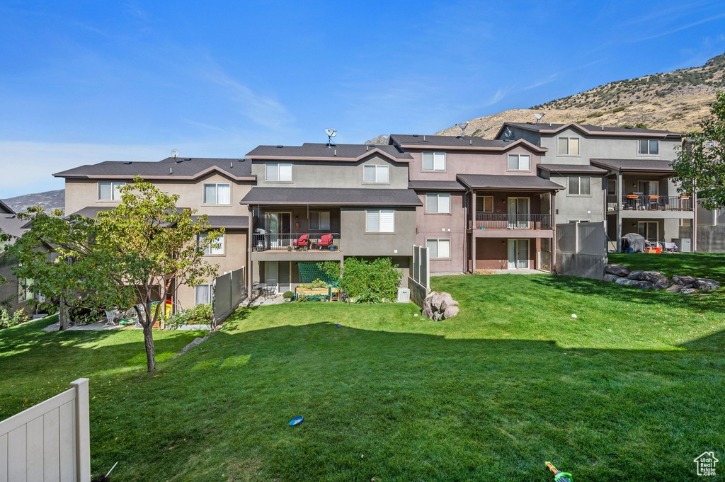 Exterior space featuring a mountain view and a lawn