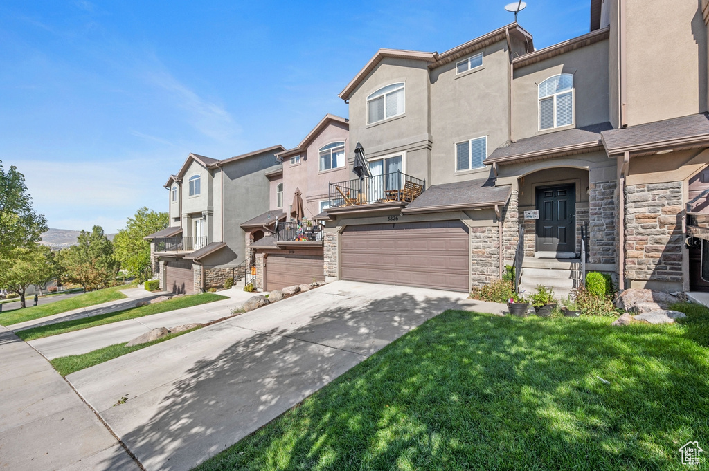 View of front facade with a front yard and a garage