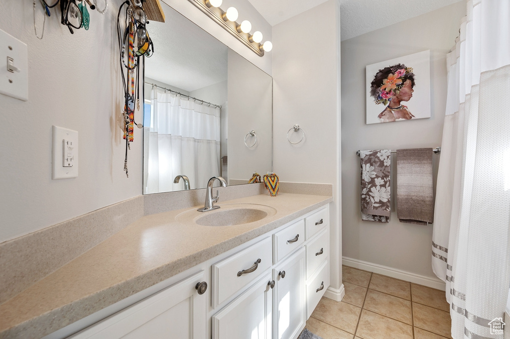 Bathroom featuring vanity and tile patterned floors