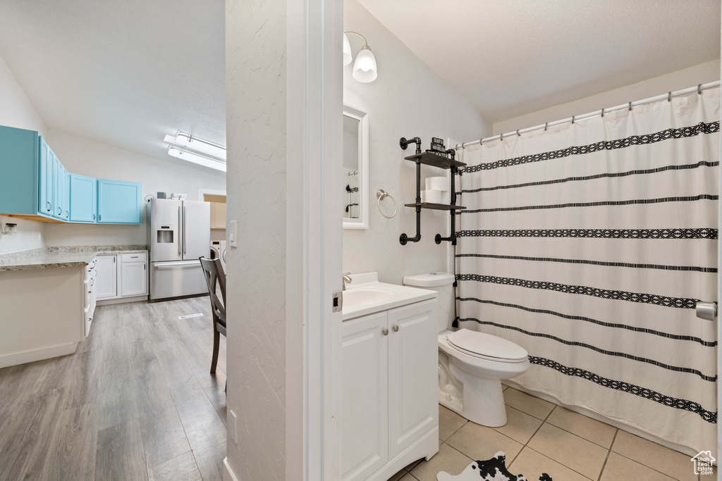 Bathroom featuring vanity, hardwood / wood-style floors, and toilet