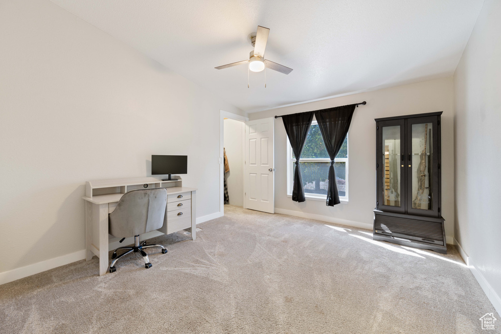 Unfurnished office with light colored carpet and ceiling fan