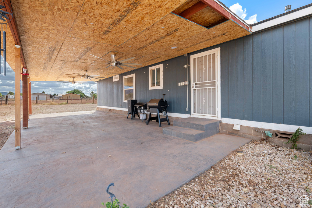 View of patio / terrace with ceiling fan and a grill